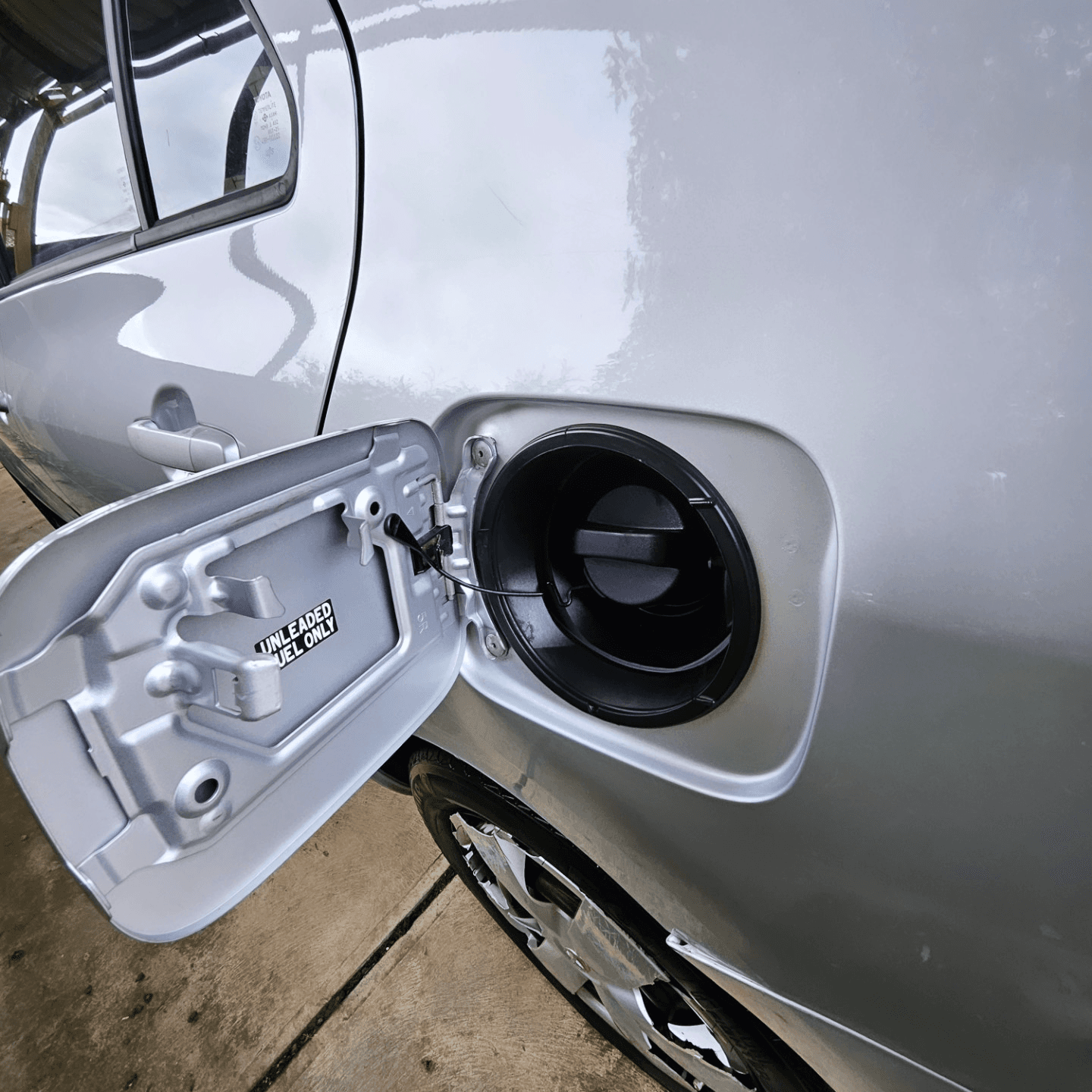 Polished silver paintwork around a car's fuel filler door